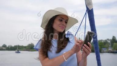 节日图片，女人在露天的手机上做图片，女人在背景海中制作自拍照片